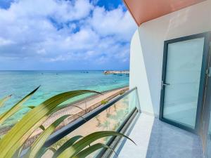 a balcony with a view of the ocean at ChanKy Hotel Dao Phu Quy in Cu Lao Thu
