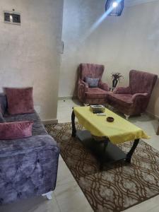 a living room with a couch and a table at اوليفيا للشقق الفندقية in Amman