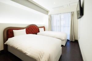 Habitación de hotel con 2 camas y TV en Hotaku HOTEL Akihabara en Tokio