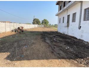 a dirt road next to a building with a fence at Uma Hotel, Chitrakoot in Sītāpur Mūāfi