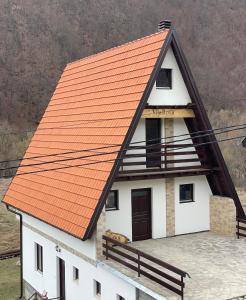 an orange roof on a white house at Vila Bosa - Stara planina in Crni Vrh