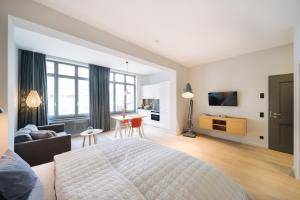 a bedroom with a large bed and a living room at Meerloft Norderney in Norderney