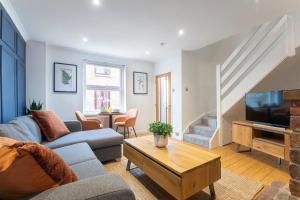 a living room with a couch and a tv at Beautiful Victoria Retreat in Cheltenham