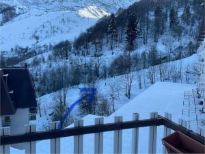 a view of a snow covered mountain from a balcony at Casa Amy in Sella della Turra +2 photos