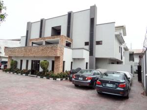 two cars parked in front of a building at S & S Hotel & Suites in Lagos