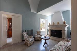 a living room with a couch and a fireplace at Palazzo Favola Dimora in town centre - Happy Rentals in Corigliano dʼOtranto