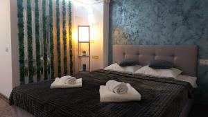 a bedroom with two white towels on a bed at Anelisse Apartments in Eforie Nord