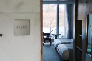 a hotel room with two beds and a window at 軽井沢天空ホテル＆リゾート in Karuizawa
