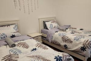 two beds sitting next to each other in a bedroom at Santorini Holiday Resort Style Staycation 3 rooms in Shah Alam +38 photos