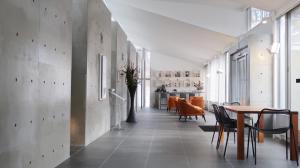 a hallway with a table and chairs and a dining room at Karuizawa Tennku Hotel & Resort in Karuizawa
