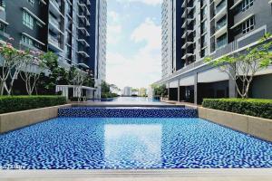 a blue swimming pool in the middle of a building at Santorini Holiday Resort Style Staycation 3 rooms in Shah Alam