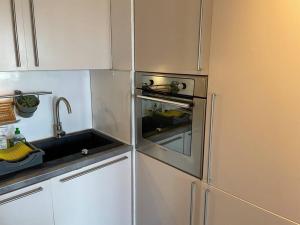 a kitchen with a sink and a stove at Magnifique 2 pièces Juan Les Pins in Antibes