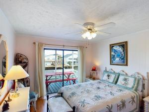 a bedroom with a bed with a ceiling fan at Crews Nest in Cherry Grove in Myrtle Beach