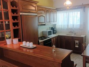 a kitchen with wooden cabinets and a wooden counter top at Kelly's penthouse in Nafpaktos