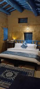 a bedroom with a large bed in a room at Idyllic Haven Heritage, Jageshwar in Jageshwar