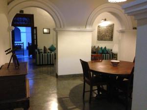 a dining room with a table and chairs in a room at Khalid's Guest House in Galle +28 photos