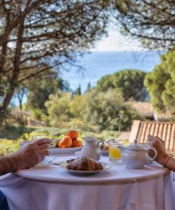 a table with a plate of food and tea on it at Villa Federica: Natura e Mare in Torre delle Stelle