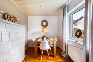 a dining room with a table and a window at Scandinavian in Schloß Holte-Stukenbrock
