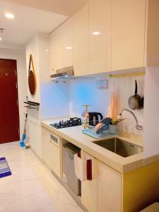 a kitchen with a sink and a counter top at Apartemen Sky House BSD by Benchmark in Tangerang