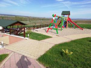 un parco con parco giochi con scivolo e panca di Complex Turistic Dávid a Boghiş