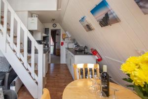 a kitchen and dining room with a wooden table at Chalet Eightyone in Deal