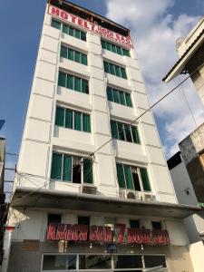 a white building with a sign on it at Seven Stars Hotel in Ho Chi Minh City