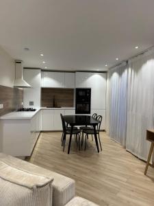 a kitchen and dining room with a table and chairs at Appartement Bezons - La Défense in Bezons