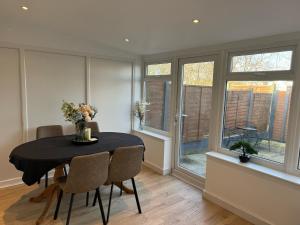 a dining room with a table and chairs and windows at Elegant 2BD Family Retreat Blackpool Town in Blackpool