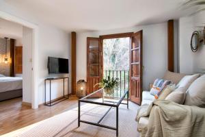 a living room with a couch and a glass table at CMH Alhambra Dreams - Luxury & Romantic Hideaway in Granada