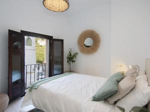 ein Schlafzimmer mit einem großen Bett und einem Spiegel in der Unterkunft Chezmoihomes Alhambra Boutique Terrace in Granada