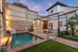 a swimming pool in the backyard of a house at ChezmoiHomes Carmen de Apperley in Granada