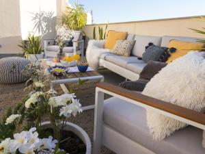 a living room with a couch and a table at Chezmoihomes Luxury Penthouse in Granada