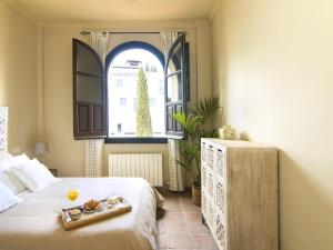 a bedroom with a bed with a tray of food on it at Mirador de los arcos Alhambra in Granada +34 photos