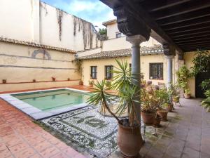 a house with a swimming pool in a courtyard at Mirador de los arcos Alhambra in Granada