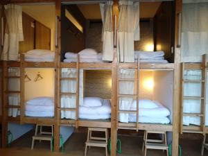 eine Gruppe Etagenbetten in einem Zimmer in der Unterkunft Cafe&Hostel きみといちご in Osaka