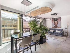 a living room with a glass table and chairs at Luxury Alhambra Penthouse Collection in Granada