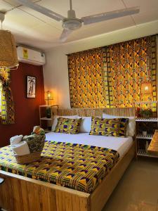 a bedroom with a large bed in a room at African Treasure Beach Resort in Kokrobite