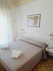 Postel nebo postele na pokoji v ubytování Hotel Helvetia