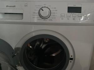 a close up of a washing machine at L'escale chez Kalou in La Rivière