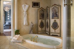 a bathroom with a bath tub in a room at The Chanler at Cliff Walk in Newport +158 photos