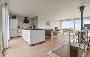 an open kitchen and dining room with white appliances at Rnnebo in Nyborg