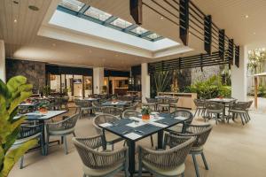 a dining room with tables and chairs in a restaurant at Voila Bagatelle in Moka