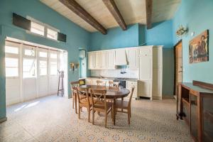 a kitchen with a table and chairs in a room at Vallettastay Standard Apartments in Valletta in Valletta