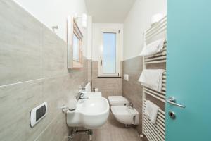 a bathroom with a white sink and a toilet at Hotel Cristallo in Rimini