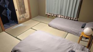 a room with two beds and a window at Yukiumi Furano in Furano