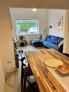 a living room with a blue couch and a table at 3 bedroom house in Bedminster near Wapping Wharf in Bristol