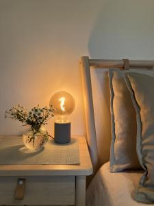 a candle on a table next to a bed at 3 bedroom house in Bedminster near Wapping Wharf in Bristol