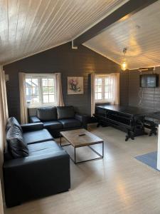 a living room with a couch and a piano at Vestby Park in Vestby