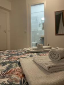 a bedroom with a bed with towels on it at B&B Cavour16 in Genoa