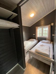a small room with two beds and a window at Vestby Park in Vestby